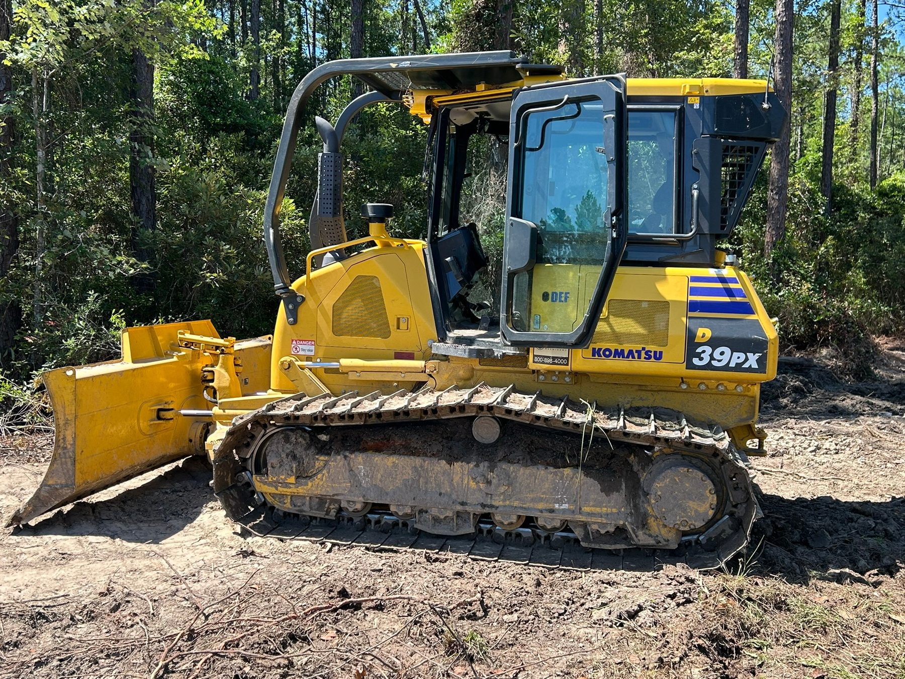 Delta Landworks Komatsu D39PX dozer on a clearing job